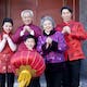 Chinese New Year family performing traditional greeting.